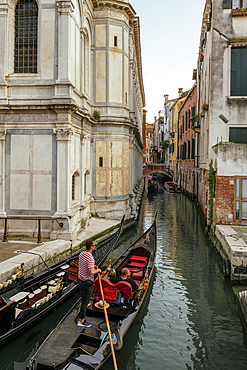 Gondola taking tourists along canals, Castello, Venice, Veneto, Italy