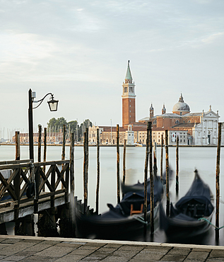 Goldolas on the lagoon at dawn, with San Giorgio Maggiore in the background, San Marco, Venice, Italy