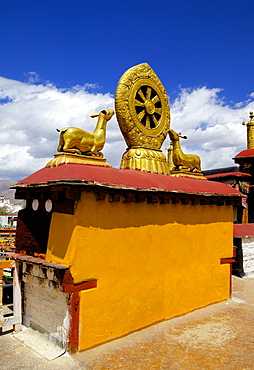 Golden Wheel of Dharma and deer sculptures on the sacred Jokhang Temple roof, Barkhor Square, Lhasa, Tibet, China, Asia 