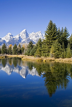 Reflected light on water from the Grand Teton Mountain Range, outside of Jackson Hole, Wyoming. This image was shot from the Schabawacker Landing on the snake river.