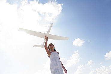 Girl flying model airplane