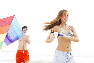 Friends flying kite on beach