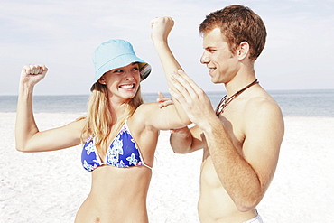 Teenage girl flexing muscles for boyfriend