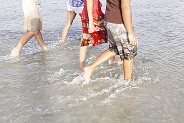 Friends wading in ocean