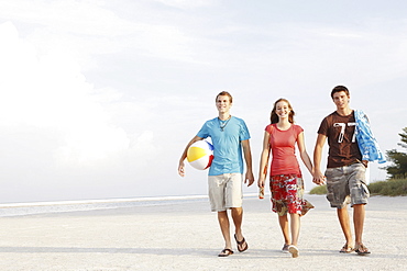 Friends walking on beach