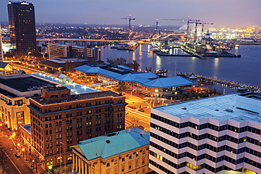 Cityscape with cranes at night, Norfolk, Virginia