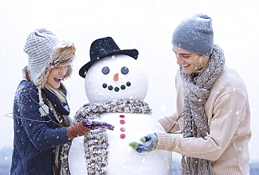 Couple making snowman