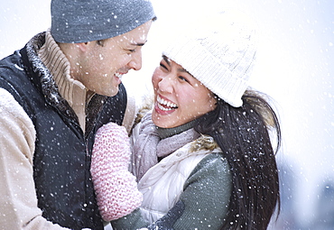 Couple wearing warm clothing having fun outside