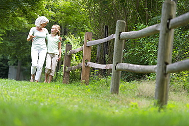 Girl (10-11) and grandmother walking together