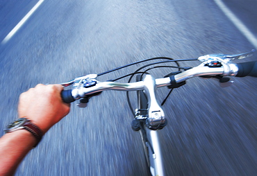 Hand gripping handlebar of bike