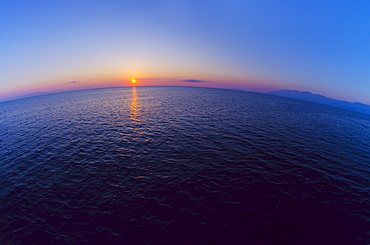 Aerial view of horizon over sea at sunrise
