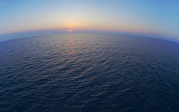 Aerial view of horizon over sea at sunrise