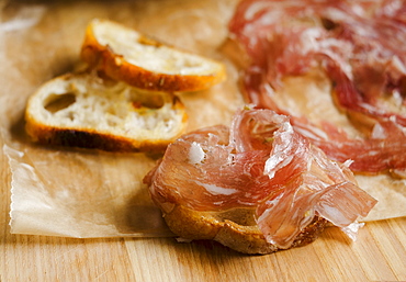 Fresh prosciutto ham with bread