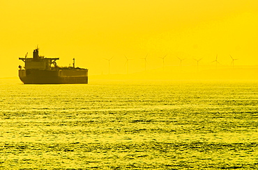 Turkey, Oil tanker on sea with wind turbines in background