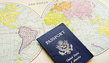 Close-up of passport lying on map