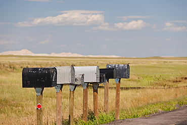 USA, South Dakota, Row of rural mailboxes on roadside in Buffalo Gap National Grasslands