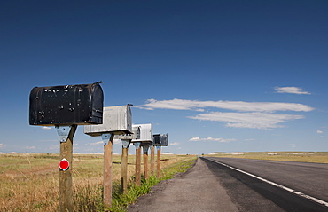 USA, South Dakota, Row of rural mailboxes on roadside