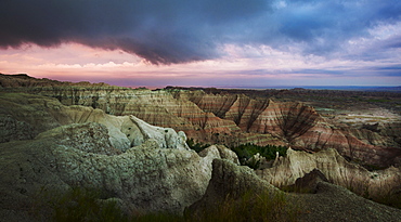 USA, South Dakota, Thick gray clouds over mountains in Badlands National Park