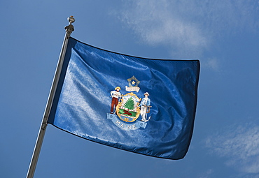 USA, Maine State flag against sky