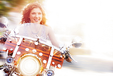 Young woman riding motorcycle