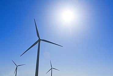 Wind turbine against blue sky