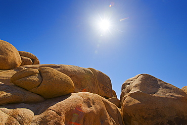 USA, California, Joshua Tree National Park, Desert rocks with solar flare, USA, California, Joshua Tree National Park