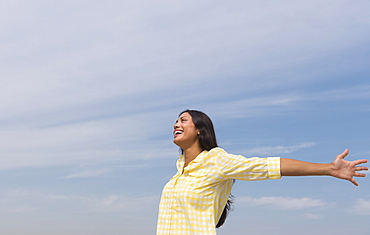 Happy woman against blue sky 