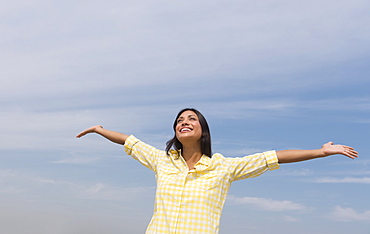 Happy woman against blue sky 