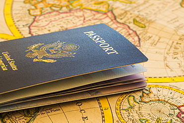 Passport sitting on antique map