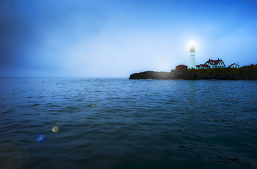 Remote coastline with lighthouse, Portland, Maine