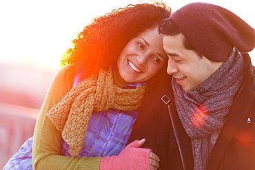 Portrait of happy couple embracing at sunset