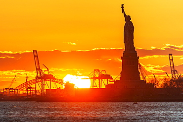 Silhouette of Statue of Liberty at sunset, New York City, New York