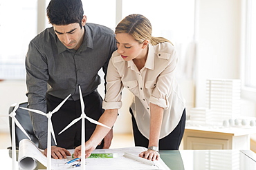 Architects looking at scale models of wind turbines