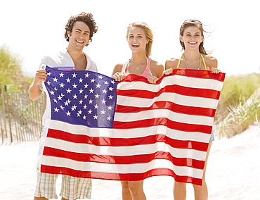 Friends holding American flag