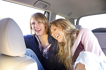 Two women in backseat of car