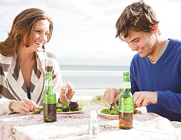 Couple eating at the beach