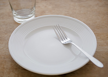 White plate with fork and glass