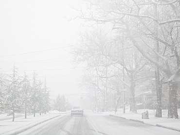 USA, New York State, Rockaway Beach, car on road during blizzard