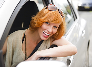 Portrait of young woman driving car