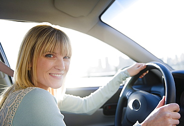 USA, Brooklyn, Williamsburg, Portrait of blonde woman driving car