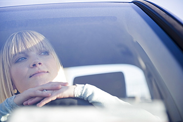 USA, Brooklyn, Williamsburg, Portrait of blonde woman driving car