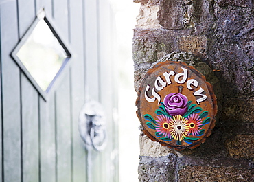 Ireland, County Westmeath, Garden sign on stone wall