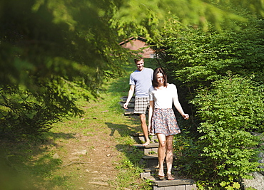 USA, New York, Putnam Valley, Roaring Brook Lake, Couple walking down steps among trees