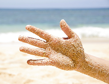 Woman's hand with sticking sand, USA, Hawaii, Kauai, Princeville