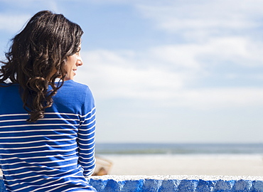 Woman relaxing on beach, Rockaway Beach, New York