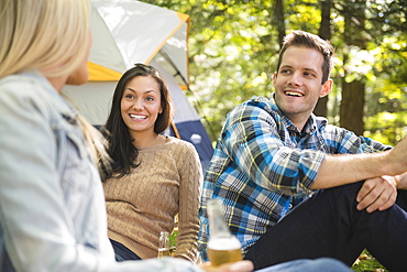 Three friends camping in forest, Newtown, Connecticut