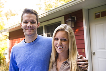 Couple in front of cottage, Newtown, Connecticut