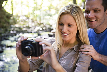 Couple taking picture in forest, Newtown, Connecticut