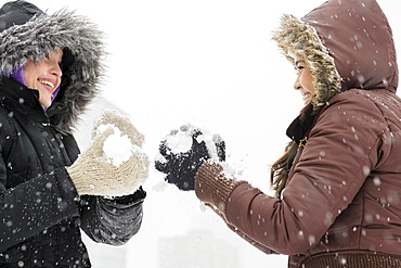 Two young women having snowball flight 