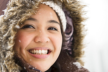 Portrait of smiling woman in warm clothing at winter